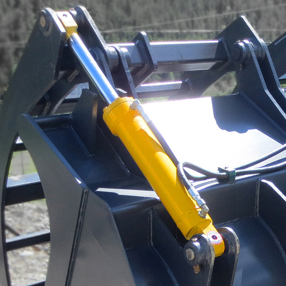 Dual heavy duty hydraulic cylinders installed onto a wheel loader corral bucket