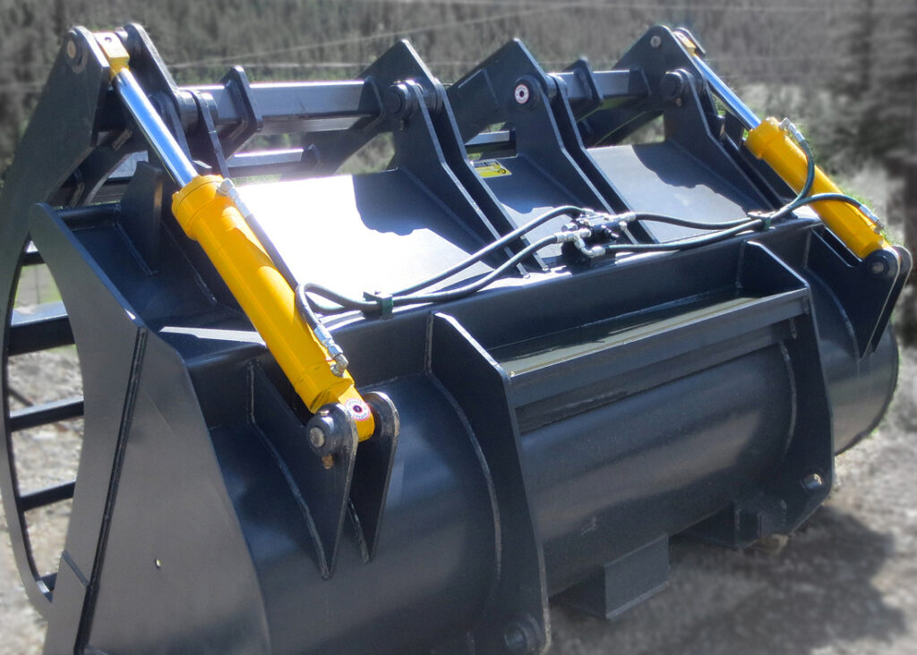 Dual heavy duty hydraulic cylinders manufactured by Red Raven Hydraulics.  Installed onto a wheel loader corral bucket used for agriculture and farming